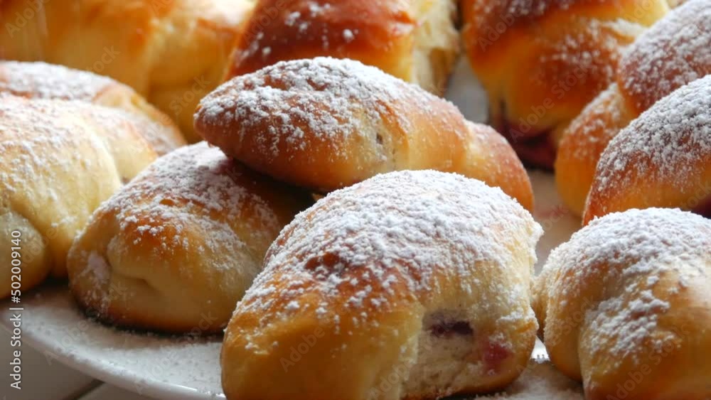 Fresh ruddy homemade bakery pastry. Homemade croissants Sprinkled with powdered sugar