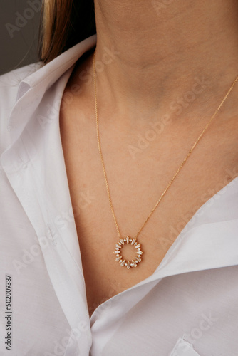 Close-up young woman wearing gold chain necklace. Modern fashion details. minimalist lifestyle