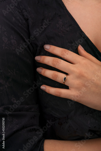 Golden Ring on a female hand, diamonds Diamond ring in hands of young lady. Close-up photo shoot