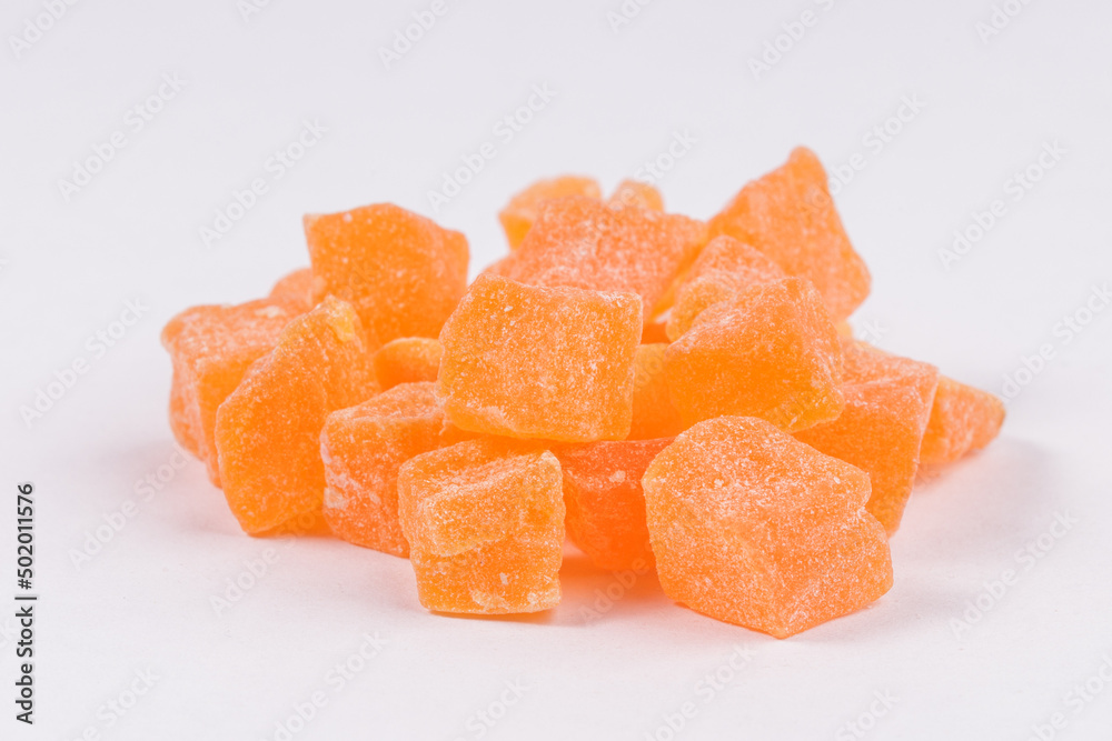 a bunch of orange candied fruits close-up. sweet dessert a bunch of orange candied fruits close-up. sweet dessert