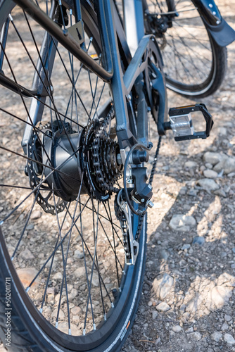 Close and selective focus on the rear cogs, gearing and chain set of an electric bike