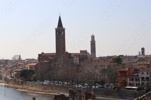 Verona, Italy-March 19, 2022: Beautifull old buildings of Verona. typical architecture of the medieval period. Aerial view to the city with blue sky in the background, beautiful view to adige river.