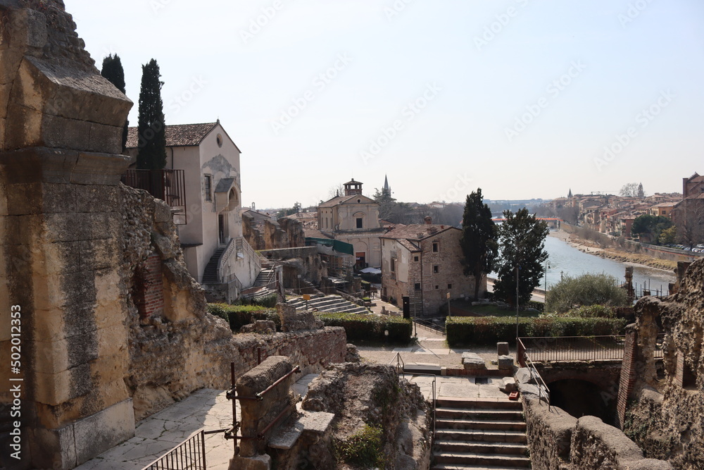 Verona, Italy-March 19, 2022: Beautifull old buildings of Verona. typical architecture of the medieval period. Aerial view to the city with blue sky in the background, beautiful view to  adige river.