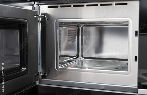 new clean stainless microwave built in with grill. modern kitchen appliance. selective focus