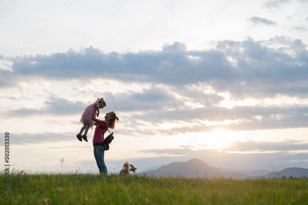 Young mother enjoying life with her daughter outside in nature Young mother enjoying life with her daughter outside in nature