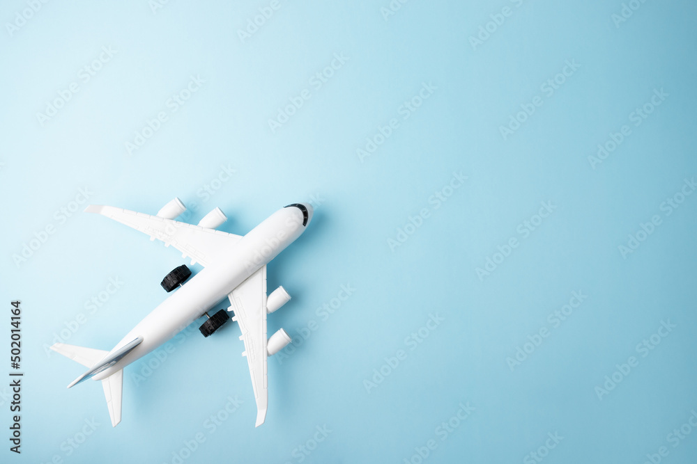 plane and on a blue background, copy space, foreign tours, ticket mobile application, air ticket booking, travel, tourism and vacation, summer relax, top view plane and on a blue background, copy space, foreign tours, ticket mobile application, air ticket booking, travel, tourism and vacation, summer relax, top view