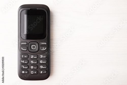 button cellphone, mobile phone, handset, cheap disposable device