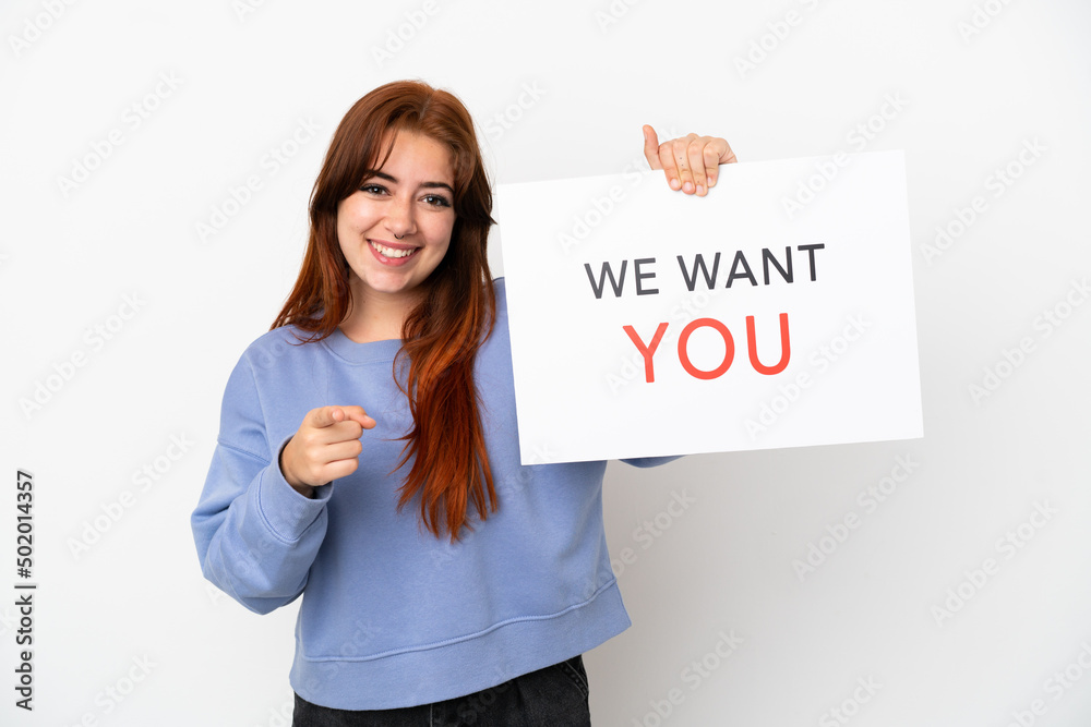 Young redhead woman isolated on white background holding We Want You board and pointing to the front Young redhead woman isolated on white background holding We Want You board and pointing to the front