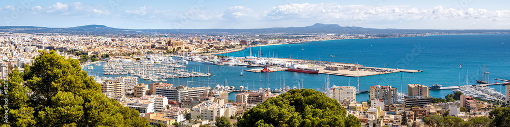Panorama view from elevated castle Castell de Bellver over the bay of Palma de Mallorca with old town, cathedral La Seu, marina, harbor to the airport and famous beach Platja de Palma at the horizon.