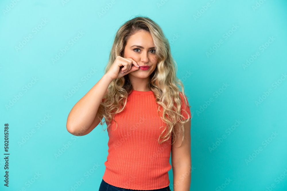 Young Brazilian woman isolated on blue background showing a sign of silence gesture Young Brazilian woman isolated on blue background showing a sign of silence gesture