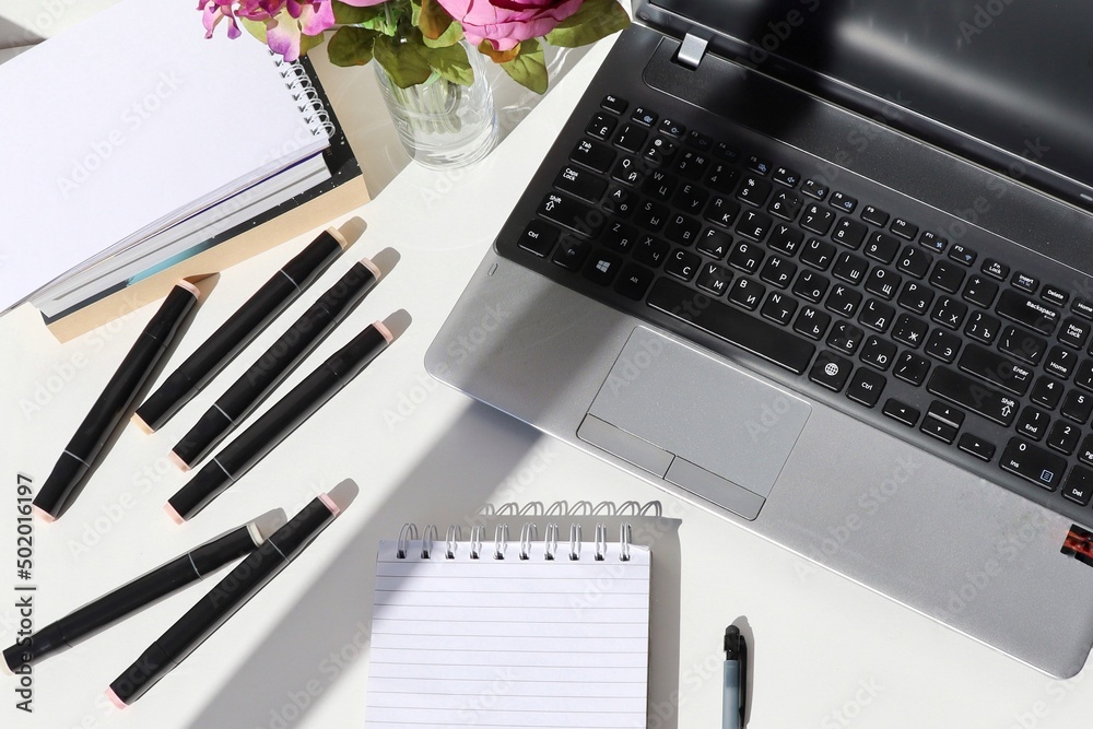 notebook with notebook and pens on the table on white background top view notebook with notebook and pens on the table on white background top view