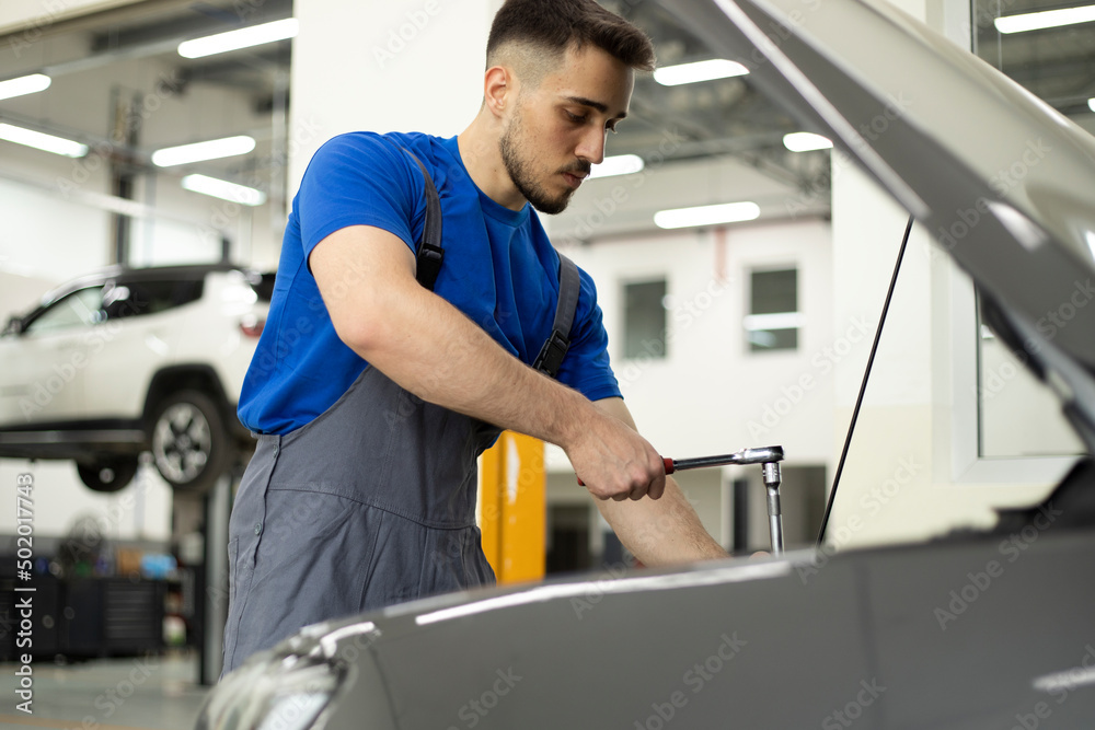 young worker working at auto service young worker working at auto service