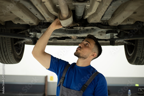 young worker working at auto service