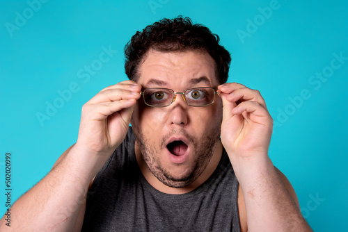 Surprise and shock. Funny fat man with glasses.