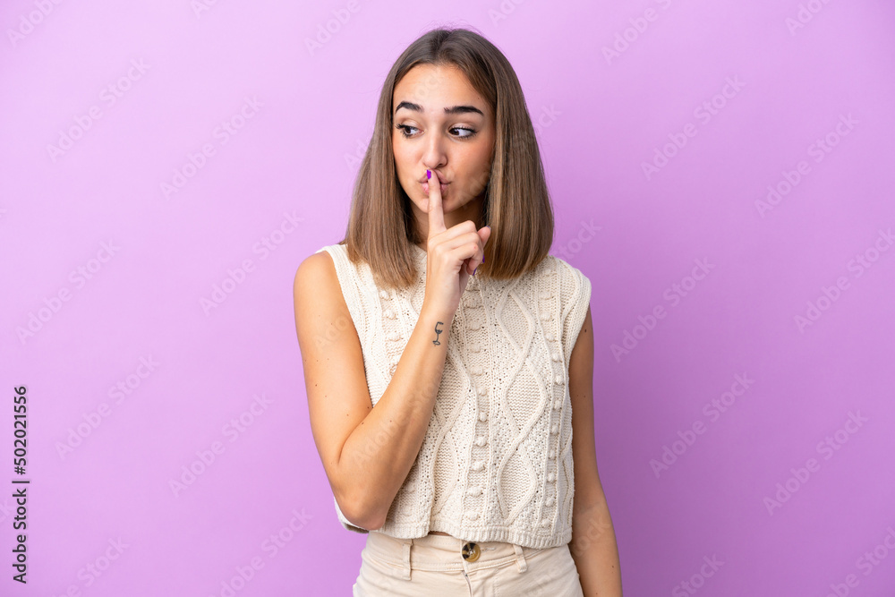 Young caucasian woman isolated on purple background showing a sign of silence gesture putting finger in mouth Young caucasian woman isolated on purple background showing a sign of silence gesture putting finger in mouth