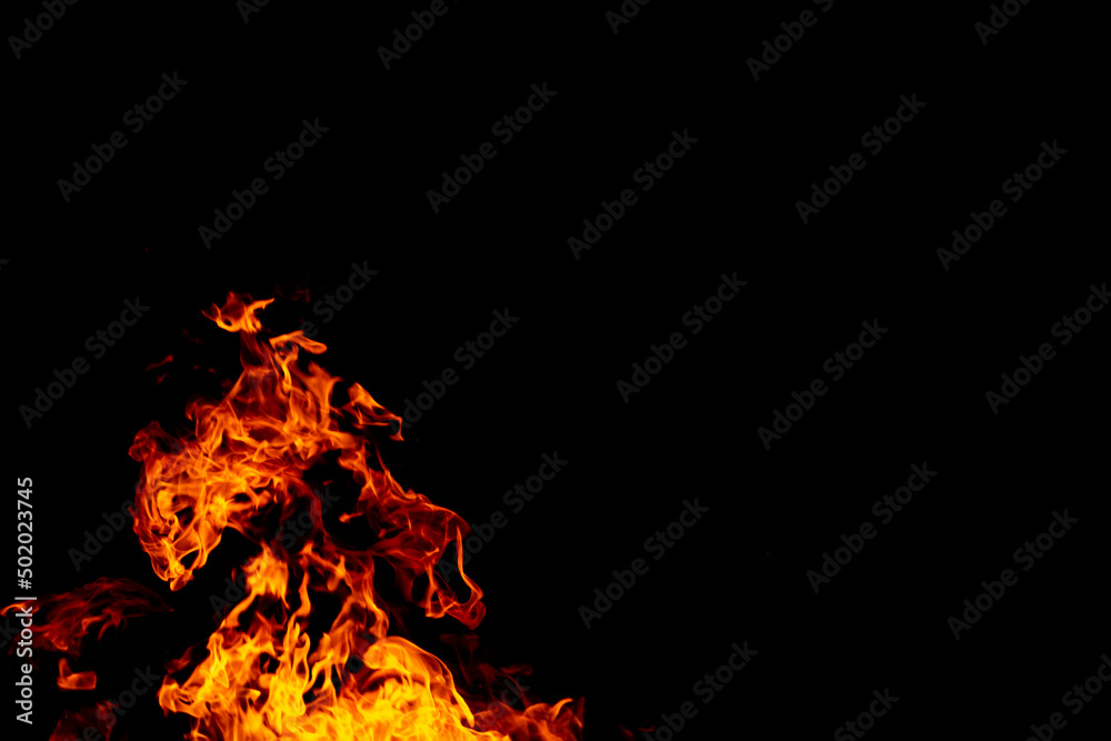 Bright fiery symbol on a black background. Fire background. Fire flame on a black background