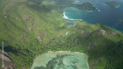 Aerial tilt up and lift up over bay Ternay overlooking northwest coast