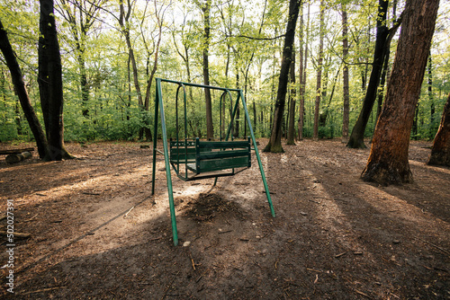 Green swing in the woods