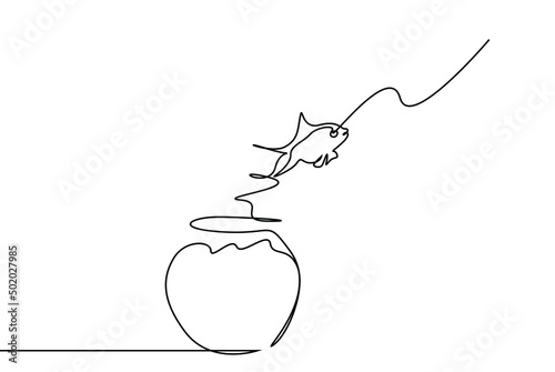 A fish jumping out of the aquarium is in the air. concept of taking action to try new things