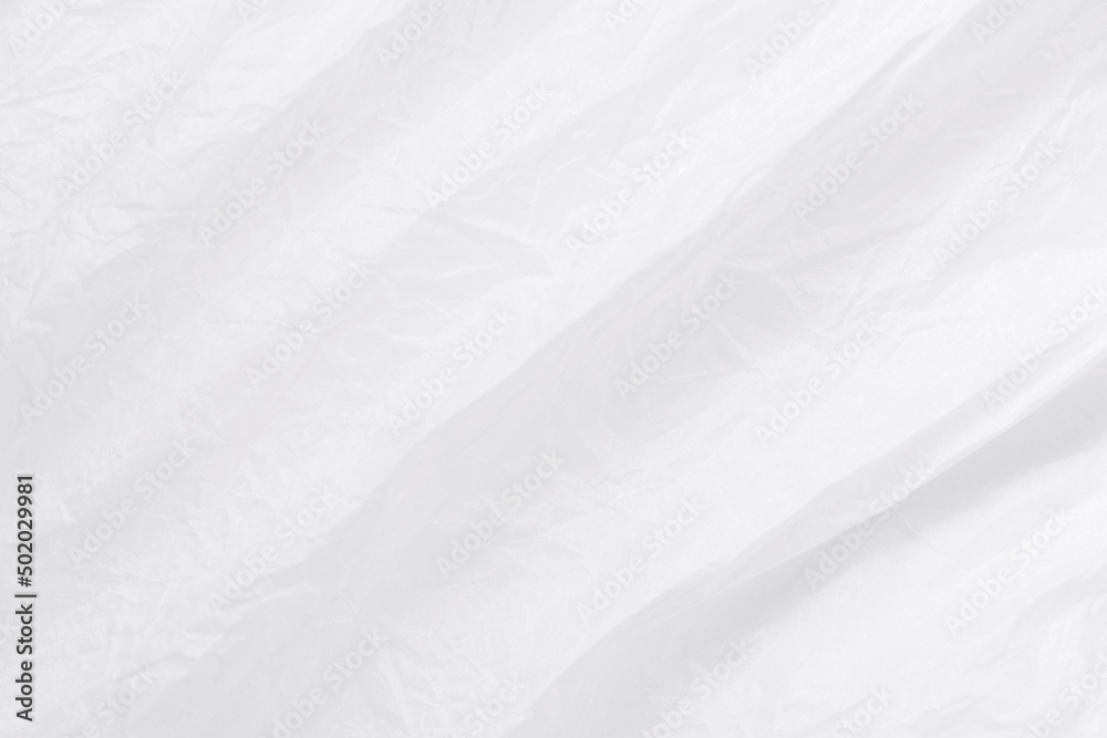 White wrapping paper wrinkled with lines backdrop. Texture of white crumpled paper macro shot. Abstract white paper background. White wrapping paper wrinkled with lines backdrop. Texture of white crumpled paper macro shot. Abstract white paper background.