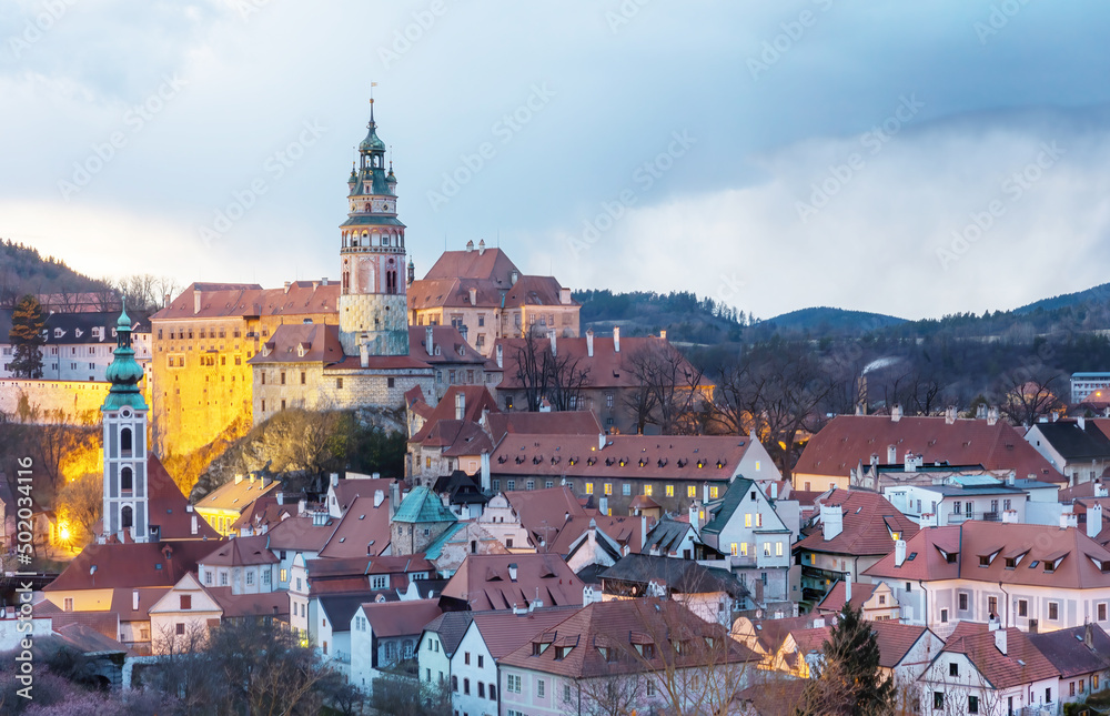 Fototapeta premium Beautiful view to Cesky Krumlov castle and its tower in Czech republic at sunset with dramatic clouds. Horizontally.