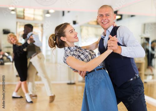 Man and woman learning to dance classical ballroom dance photo