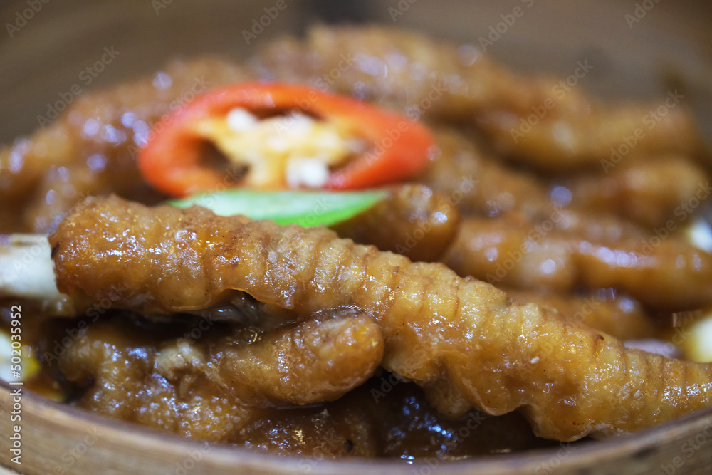 extreme close up of Abalone sauce chicken feet in steamer. Traditional Cantonese cuisine extreme close up of Abalone sauce chicken feet in steamer. Traditional Cantonese cuisine