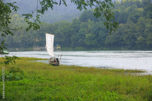 a white sailing boat on the river, Spring Scenery of Songyang ancient village in Lishui, Zhejiang Province photo