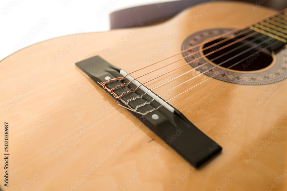 Obraz premium A part of brown wooden classic guitar. Six strings