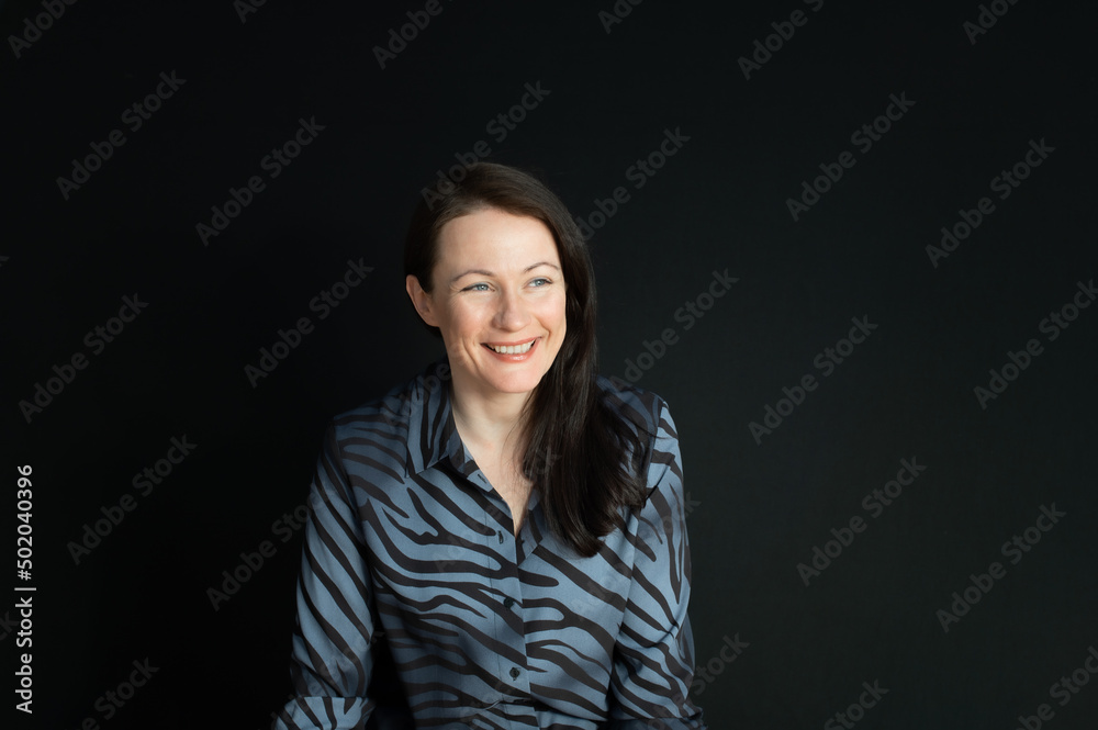 portrait of a sincere smiling mature woman on a black background portrait of a sincere smiling mature woman on a black background