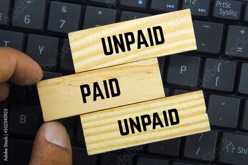 wooden boards with the words paid and unpaid