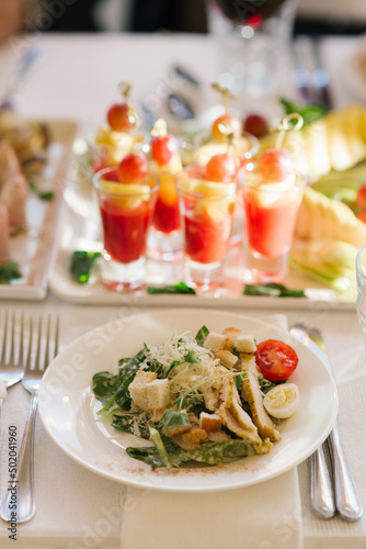 Caesar salad and snacks in glass in the serving of a festive banquet at a wedding