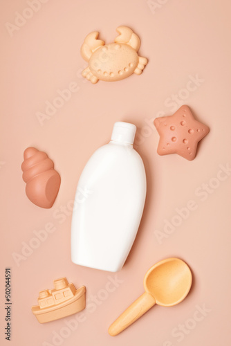 Kids summer accesories and sun screen bottle for sunny days and vacations. Sand molds and sun cream for fun at the beach