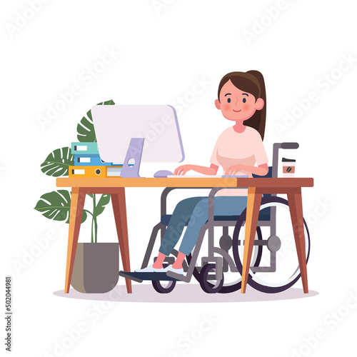 Disabled woman sits in a wheelchair at a desk at a computer.