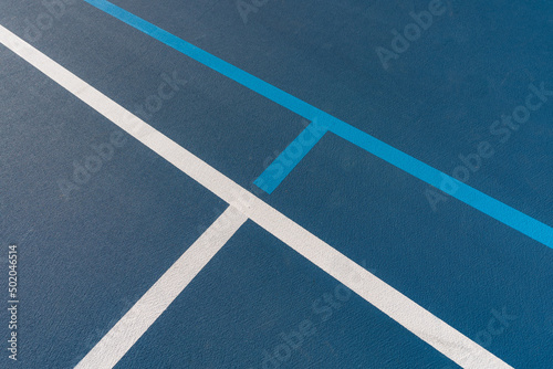 Blue tennis courts with white lines and light blue pickleball lines © Thomas