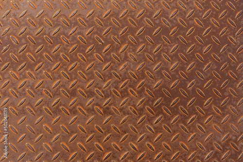 Rusted anti-slip floor panel, metal background