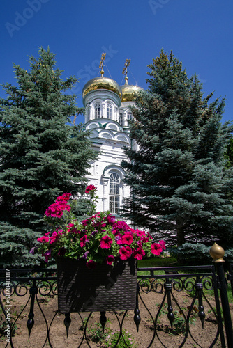 View of the Trinity Cathedral on the background of flowers in the Raifa monastery photo