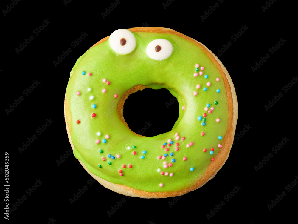 Donut with green icing and confetti with eyes Donut with green icing and confetti with eyes