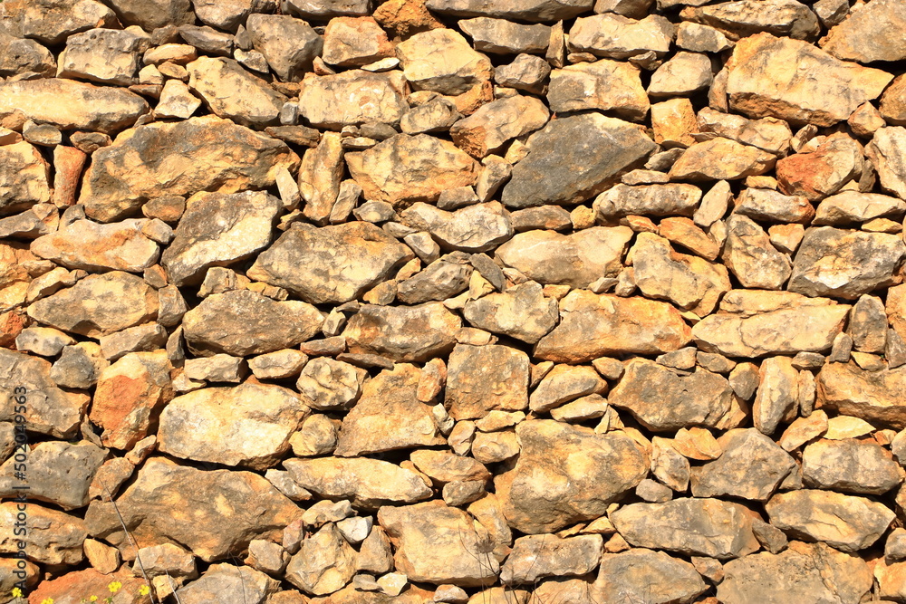 Old yellow brown masonry wall of stones Old yellow brown masonry wall of stones