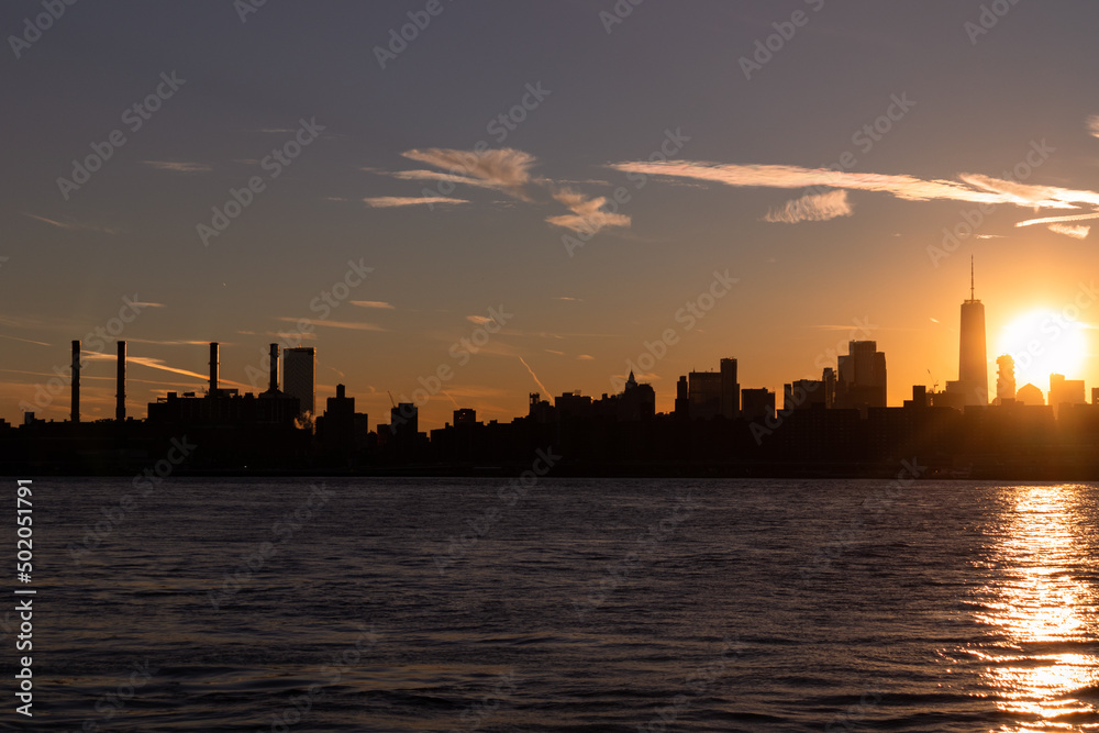 Silhouette of the Manhattan Skyline along the East River during a Sunset in New York City