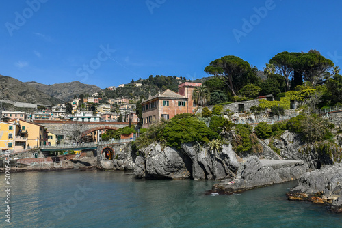View of the small port of the old fishing village with the railway arch bridge and the starting point of the Anita Garibaldi Promenade, Nervi, Genoa, Liguria, Italy