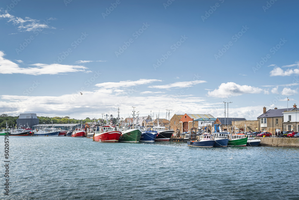Several colourful fishing boats moored in Howth harbour. Phishing and shellfish fishing equipment on fishing boats, Dublin, Ireland