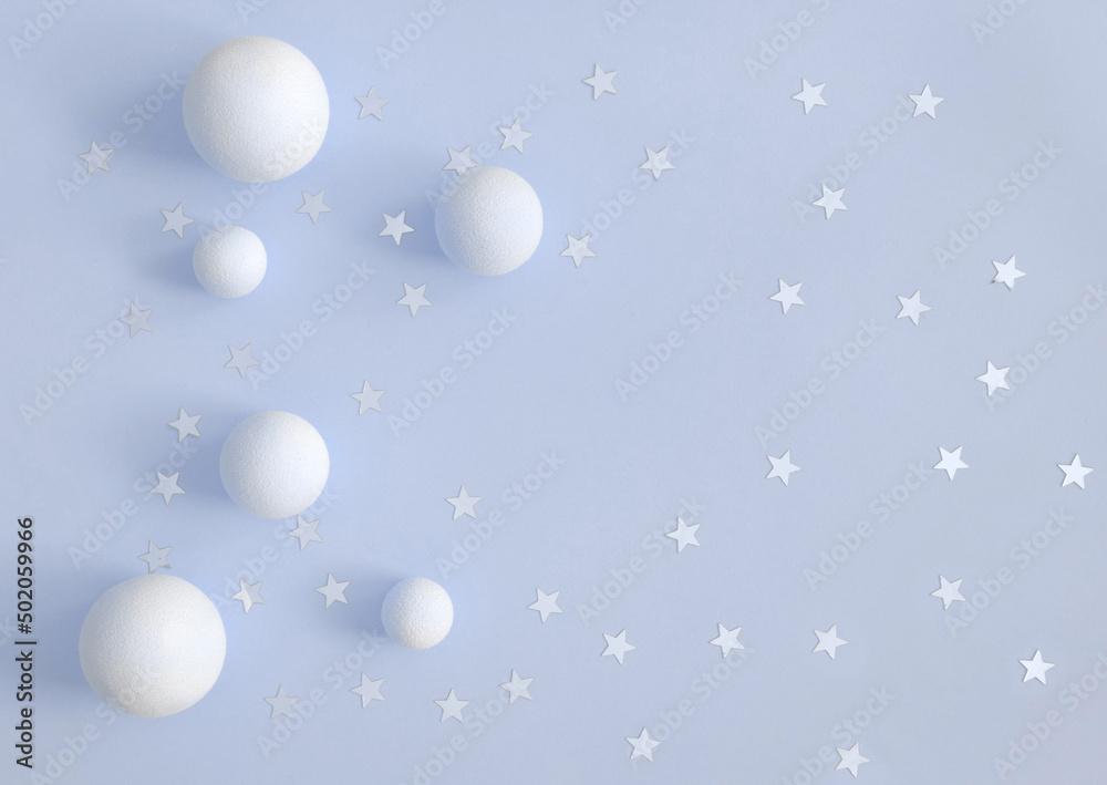 Party Time Layout with White Fluffy Balls and Silver Confetti of Star Shape on a  Pastel Blue Background. Top-Down View. No Text. Flat Lay Composition ideal for Banner, Card.