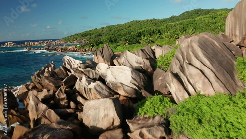 Aerial dolly over Anse Songe beach close to granite rocks and boulders