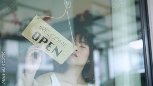 female hanging open sign