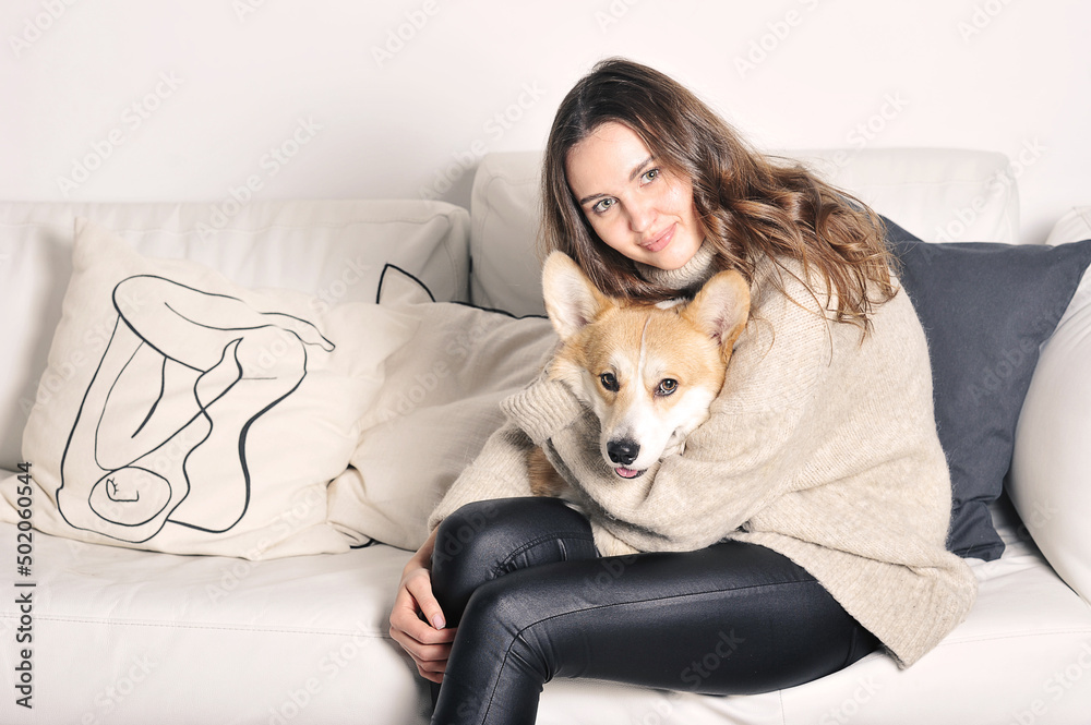 European caucasian young girl is sitting on the sofa European caucasian young girl is sitting on the sofa