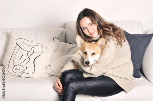 European caucasian young girl is sitting on the sofa