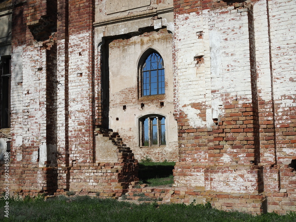 Destroyed Lutheran church of 19th century against blue sky in former canton of Schaefer in Saratov region. Outdoor.