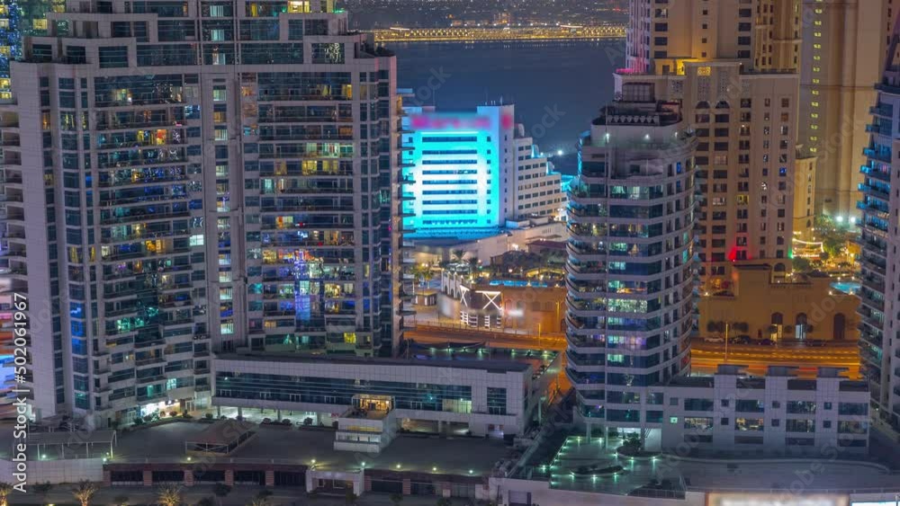 Dubai Marina skyscrapers and JBR district with luxury buildings and resorts aerial night timelapse Dubai Marina skyscrapers and JBR district with luxury buildings and resorts aerial night timelapse