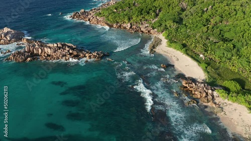 Aerial descent over emerald cove Grand l'Anse beach, Seychelles
